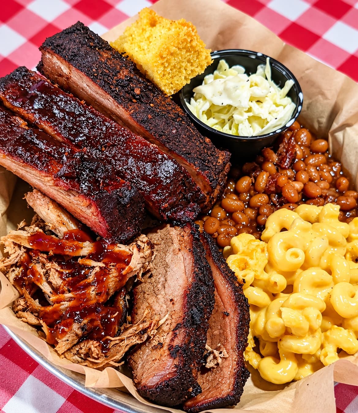 BBQ platter of ribs, brisket and pulled pork with mac and cheese, baked beans, coleslaw and cornbread