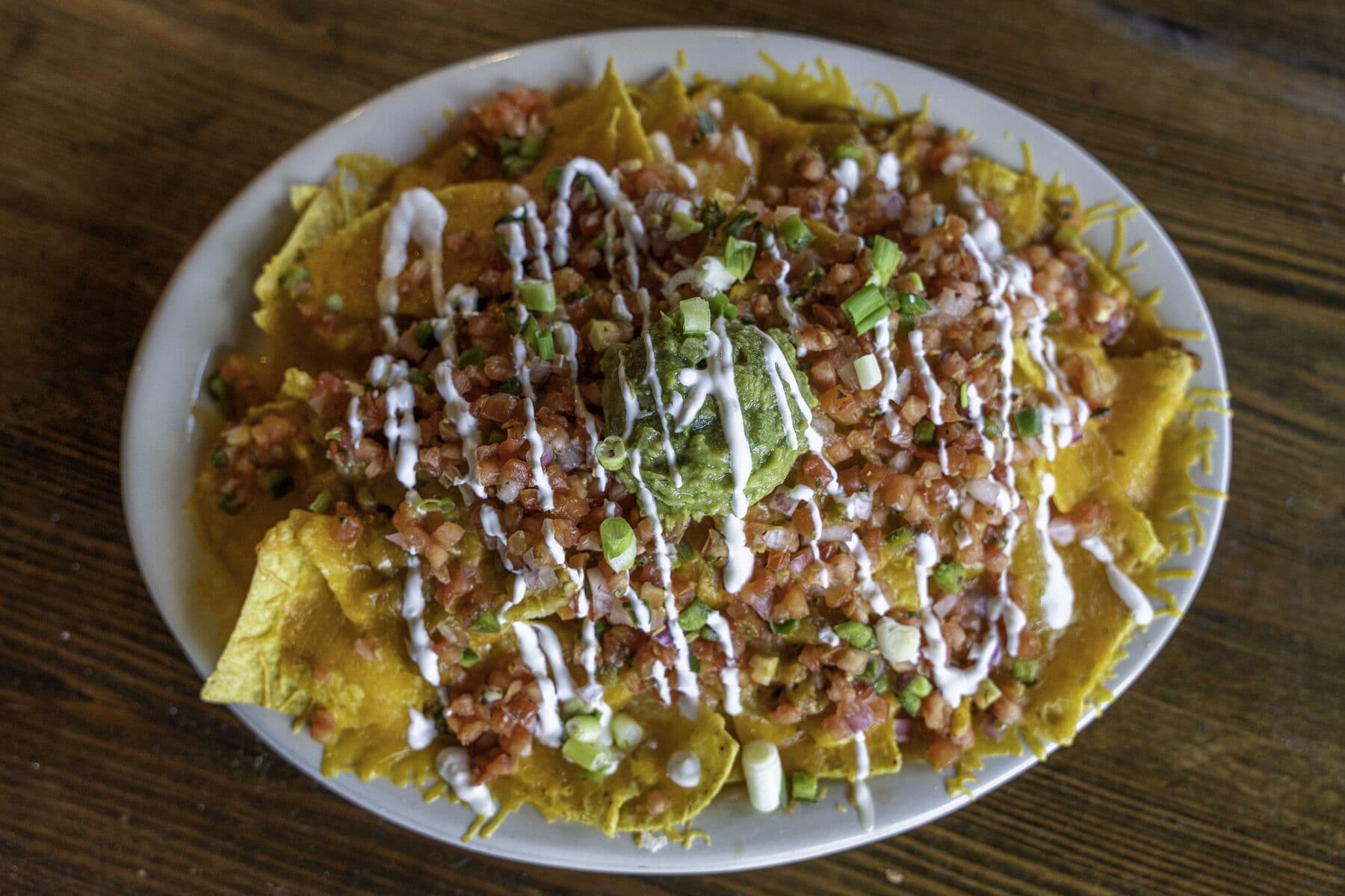 Loaded BBQ nachos with guacamole and pico de gallo
